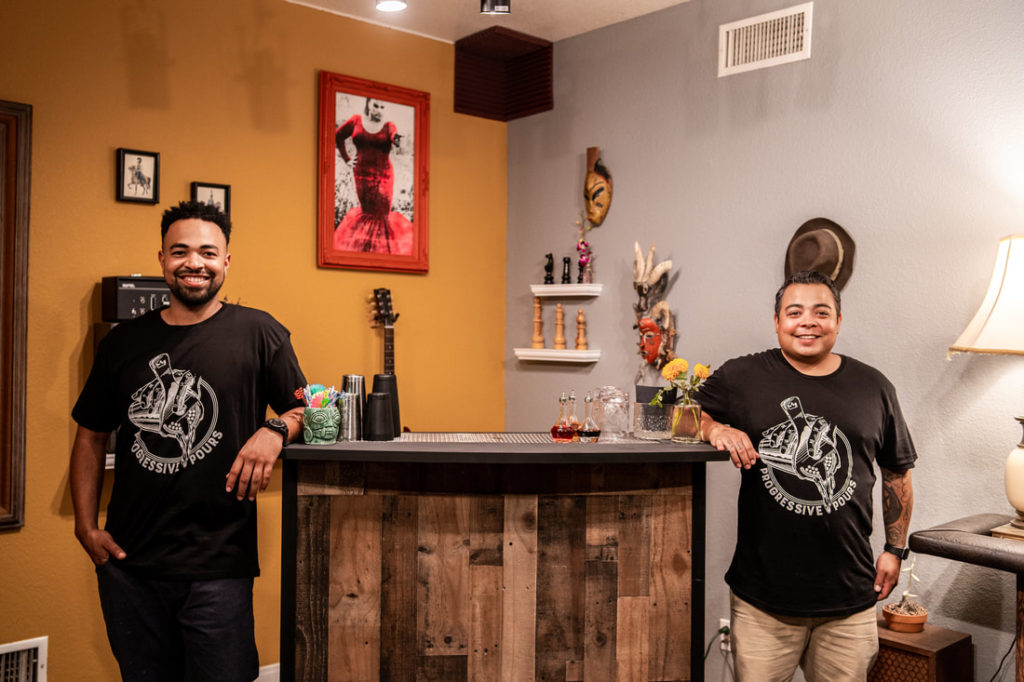 image of bartenders standing next to bar